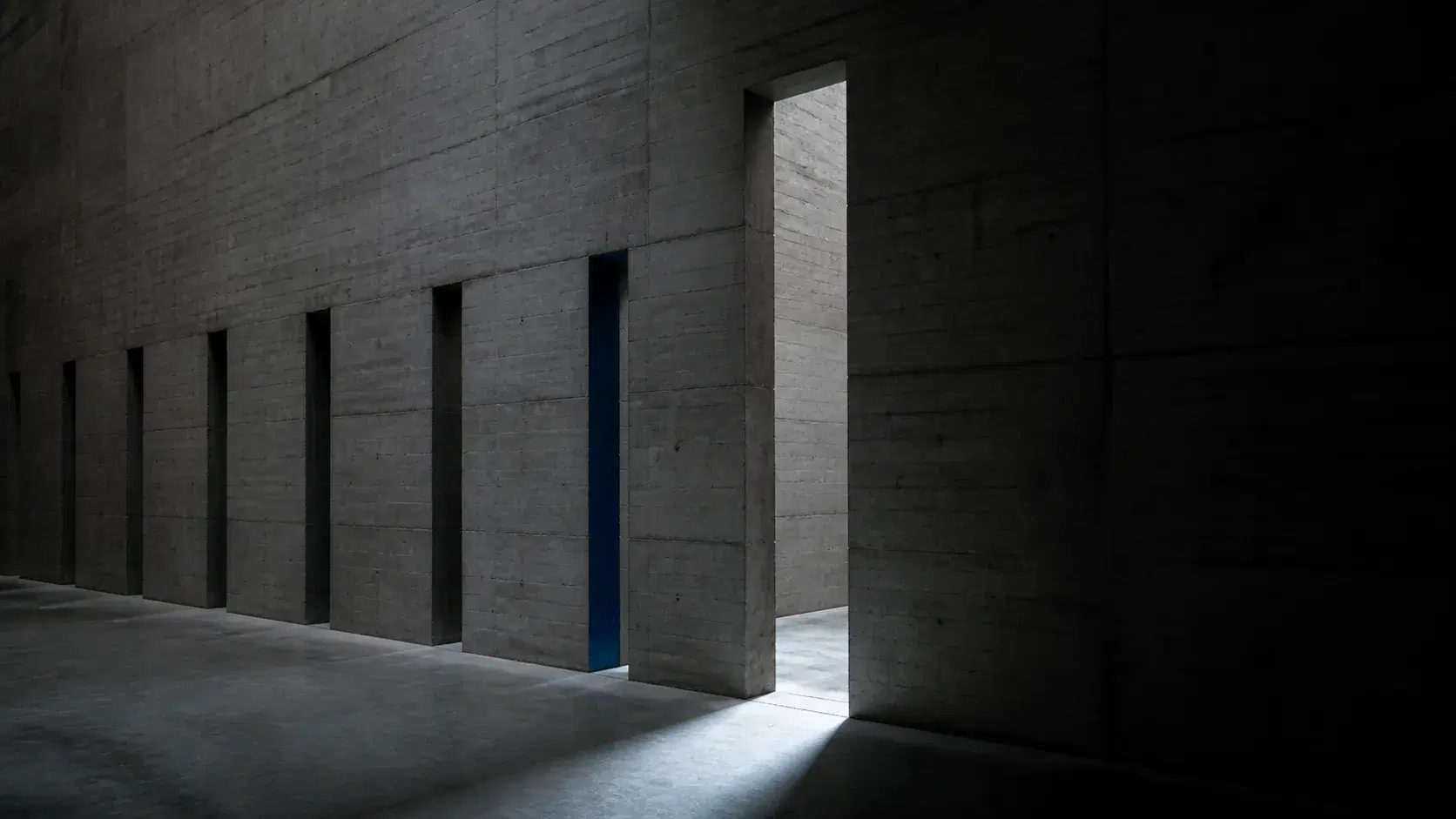 A concrete aperture with a narrow beam of light reaching the surface beyond it, representing crawler access